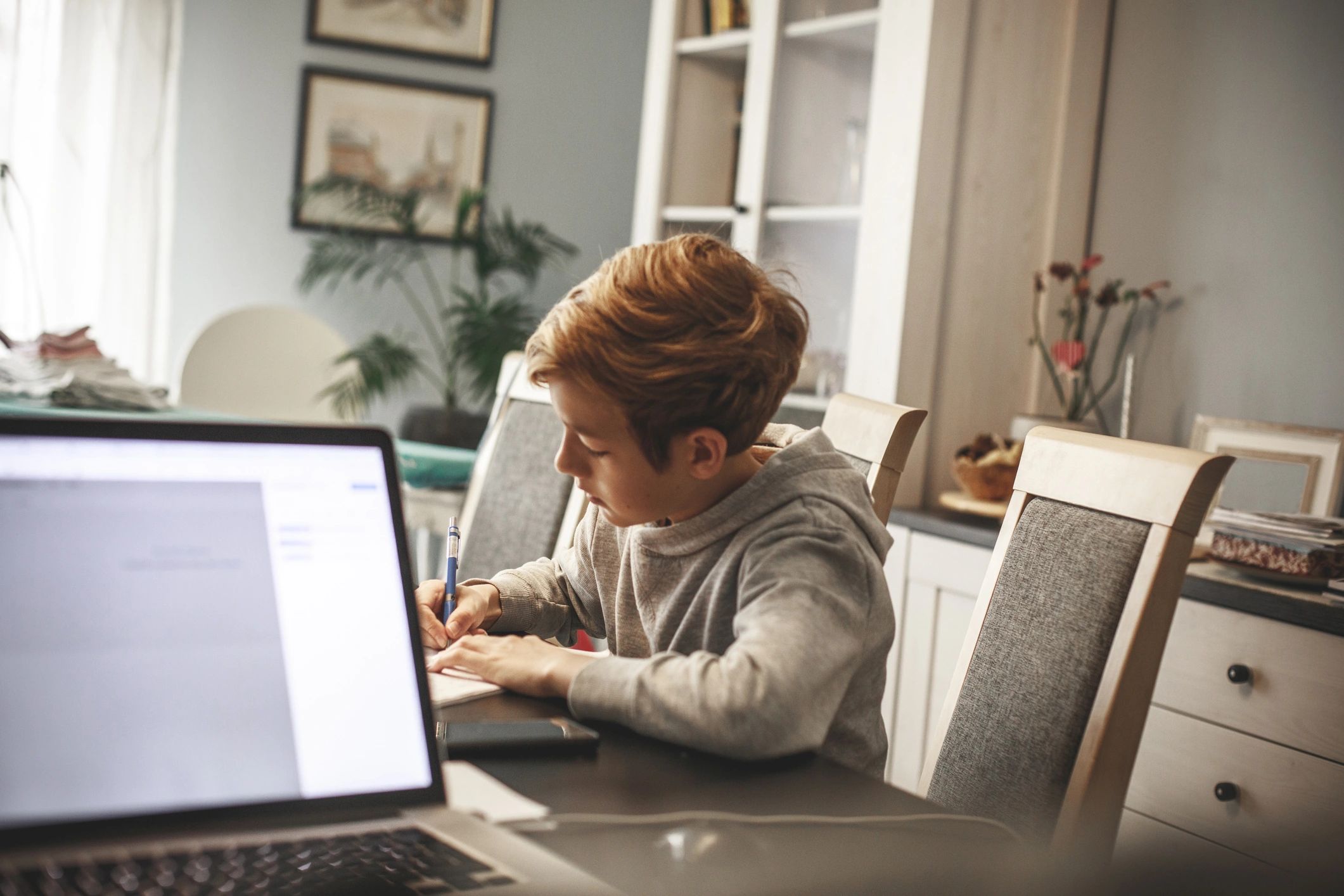 Child studying at a table during a learning session