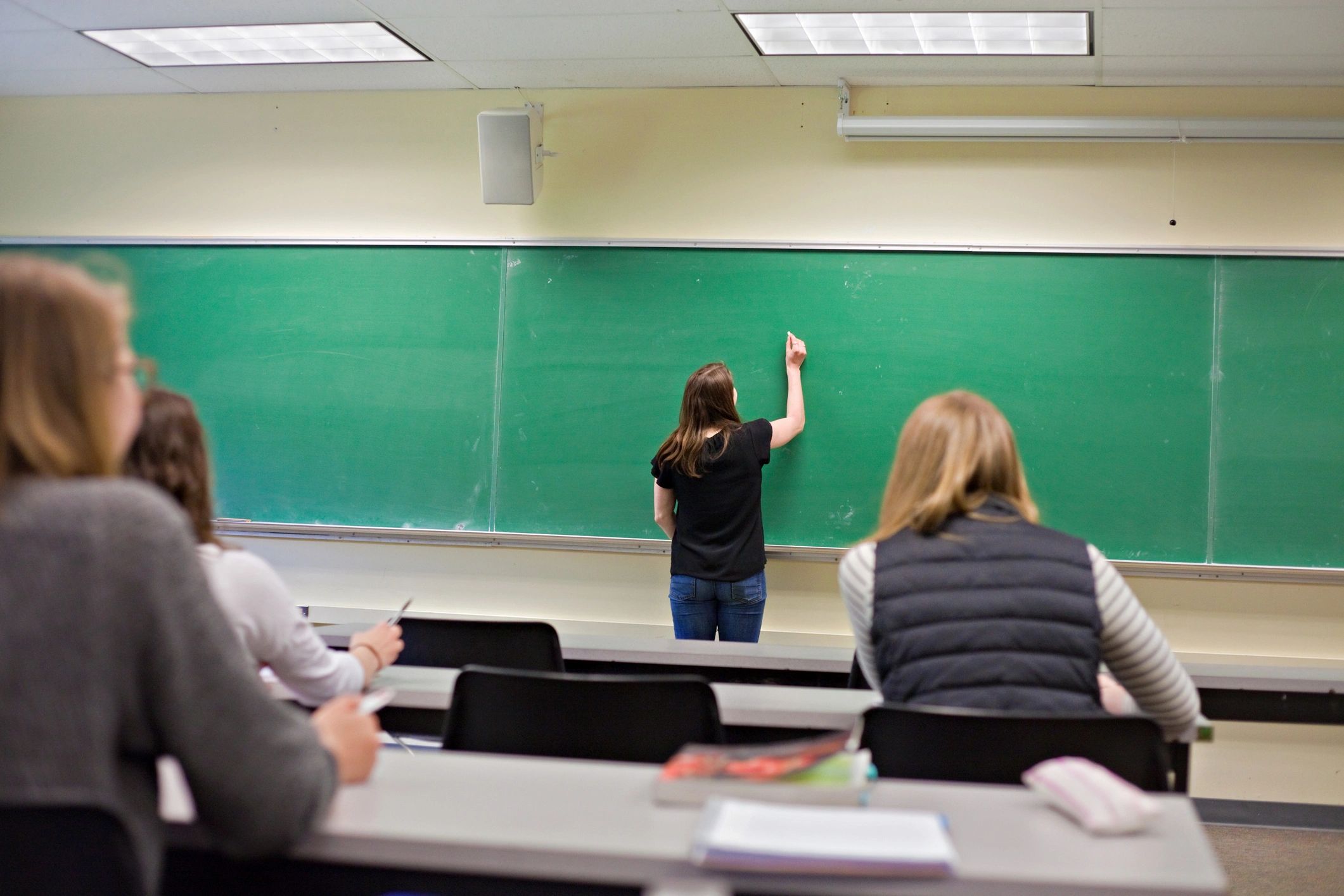 Students looking toward the board in a classroom